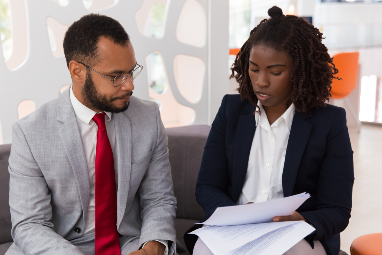 young-businesswoman-showing-contract-male-colleague